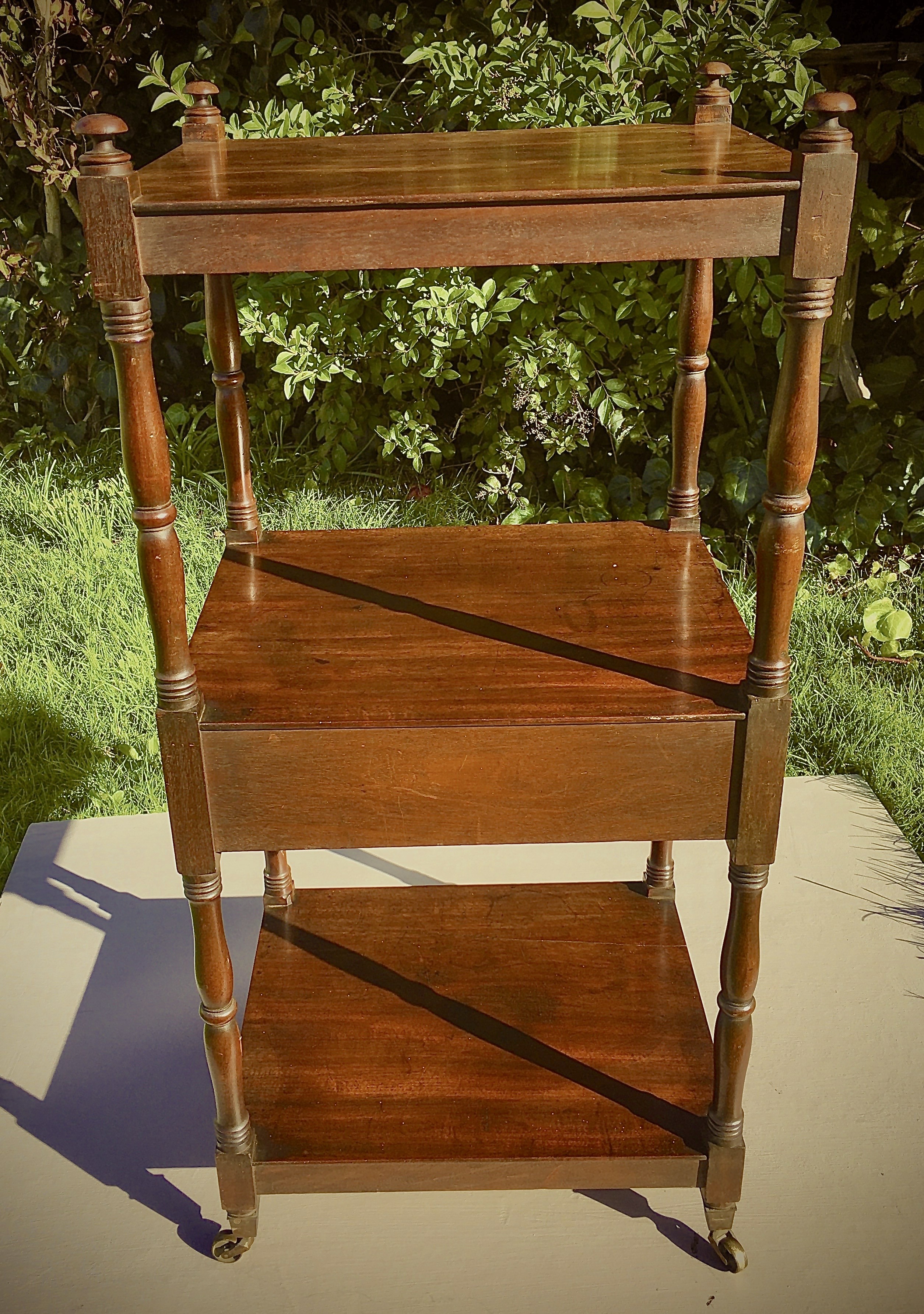 A Regency mahogany three tier whatnot fitted mid drawer, width 46cm, depth 38cm, height 98cm.